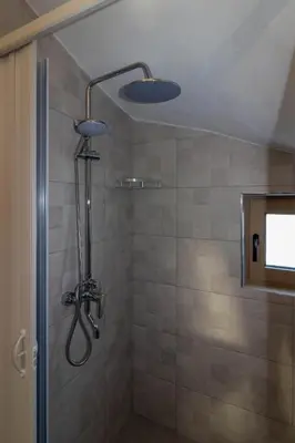 a shower with a shower head in a bathroom at Kolymbia Bella View House in Kolimbia