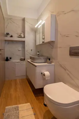 a white bathroom with a toilet and a sink at Kolymbia Bella View House in Kolimbia