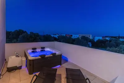 a hot tub on a balcony with blue lights at Kolymbia Bella View House in Kolimbia