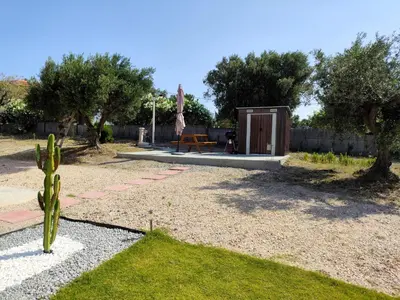 a garden with a cactus and a small shed at Kolymbia Bella View House in Kolimbia