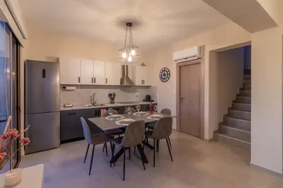 a kitchen and dining room with a table and chairs at Kolymbia Bella View House in Kolimbia