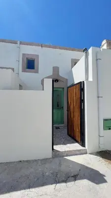 a white house with a green door and a fence at Makariospiti - Villa Vera in Malona Village