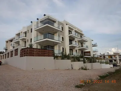 a large white building on the side of a street at Wohlfühloase 2 Casa Elena und Gerd in Rhodes Town