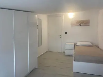 a white bedroom with a bed and a closet at Wohlfühloase 2 Casa Elena und Gerd in Rhodes Town