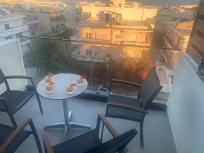 a table and chairs on a balcony with a view at Wohlfühloase 2 Casa Elena und Gerd in Rhodes Town