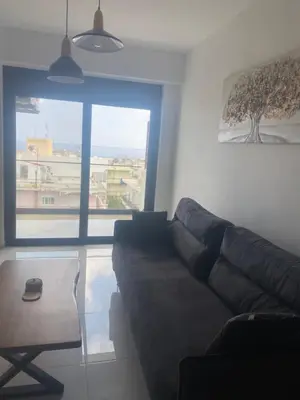 a living room with a couch and a large window at Wohlfühloase 2 Casa Elena und Gerd in Rhodes Town