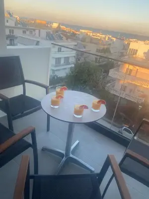 a table on a balcony with two drinks on it at Wohlfühloase 2 Casa Elena und Gerd in Rhodes Town
