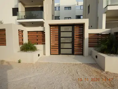 a house with a wooden door in front of a building at Wohlfühloase 2 Casa Elena und Gerd in Rhodes Town