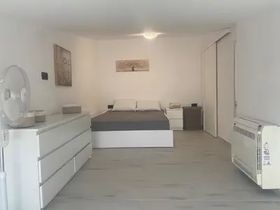 a white bedroom with a bed and a dresser at Wohlfühloase 2 Casa Elena und Gerd in Rhodes Town