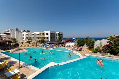 a group of people in the swimming pool at a resort at Sirene Beach Hotel in Ixia