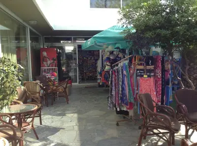 a store with chairs and a table and some clothes at Sirene Beach Hotel in Ixia