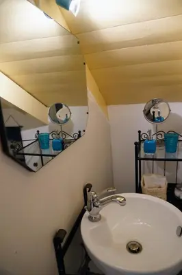 a bathroom with a sink and a mirror at Caza Rina Appartment, Symi in Symi