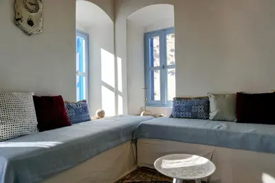 a living room with a couch and a table at Caza Rina Appartment, Symi in Symi