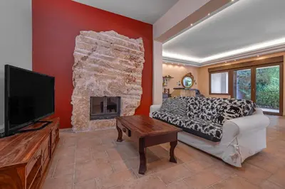 a bedroom with a bed and a fireplace at Coral Tree Luxury Villa in Ialyssos