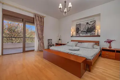 a bedroom with a large bed and a large window at Coral Tree Luxury Villa in Ialyssos