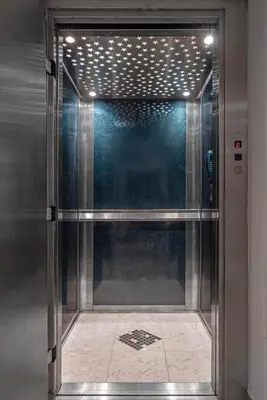 a metal elevator with a glass door in a building at Coral Tree Luxury Villa in Ialyssos