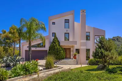 a rendering of a house with palm trees at Coral Tree Luxury Villa in Ialyssos