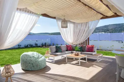 a living room with a couch and a table at Ελin Villa in Kalathos