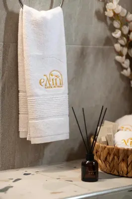 a bathroom with a towel and a basket of towels at Ελin Villa in Kalathos