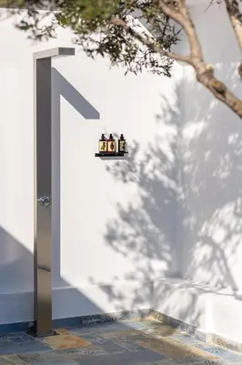 a group of three people sitting on a shelf on a wall at Ελin Villa in Kalathos