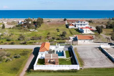 an aerial view of a house near the ocean at Ελin Villa in Kalathos