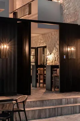 a lobby with a bar with tables and chairs at Abella Suites Embonas in Émbonas