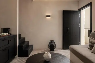 a living room with a black door and a table at Abella Suites Embonas in Émbonas