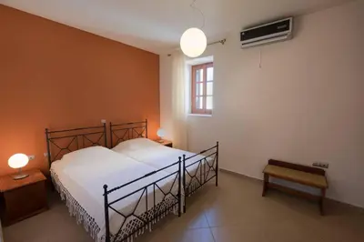 a bedroom with a bed and a window at Harbour View Modern Apartments with Terrace in Halki
