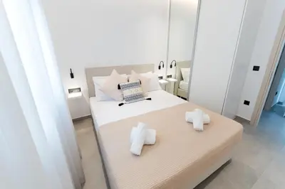 a bedroom with a bed with towels on it at Alter Ego Cozy Corner in Rhodes Town