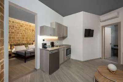 a kitchen and living room with a couch in the background at Mulberry Apartments in Rhodes Town