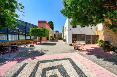 a courtyard with benches and a pattern on the ground at Mulberry Apartments in Rhodes Town