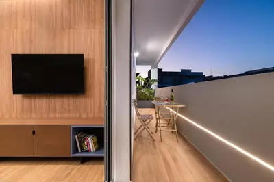 a balcony with a television and a table in a room at Onirico Apartment in Rhodes Town