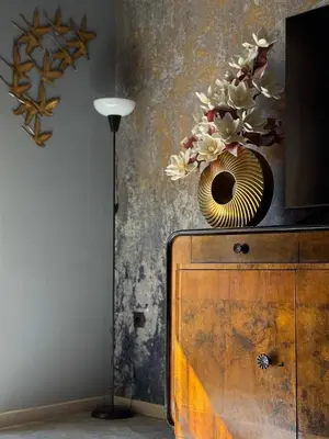 a vase with flowers on top of a wooden cabinet at Casa Assisi in Rhodes Town