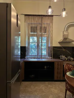 a kitchen with a refrigerator and a window at Casa Assisi in Rhodes Town