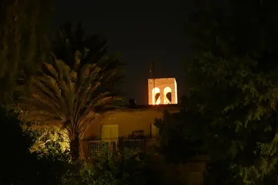 a building with a lit up tower at night at Casa Assisi in Rhodes Town
