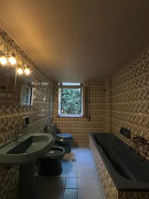a bathroom with two toilets and a sink and a tub at Casa Assisi in Rhodes Town