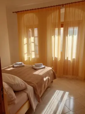 a bedroom with a bed with two towels on it at Antoni's Symi Home in Symi
