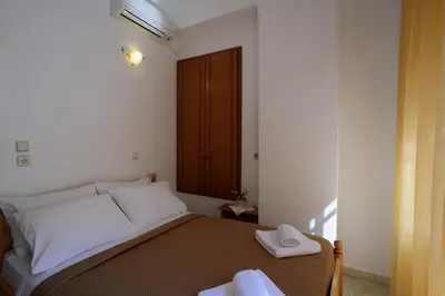 a bedroom with a bed with two towels on it at Antoni's Symi Home in Symi