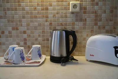 a coffee pot on a counter next to a toaster at Antoni's Symi Home in Symi
