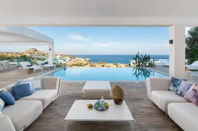 a living room with a view of the ocean at Luxury Villa Oceania Lindos with Private Infinity Pool in Líndos