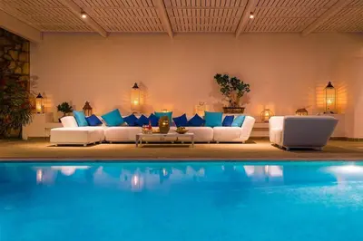 a living room with blue and white furniture and a pool at Luxury Villa Oceania Lindos with Private Infinity Pool in Líndos