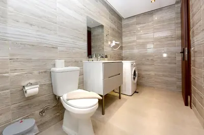 a bathroom with a toilet and a sink at Elli Garden View in Kremasti