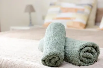 a stuffed teddy bear laying on a bed at Elli Garden View in Kremasti