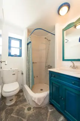 a bathroom with a toilet and a sink and a shower at Litsa Holiday Home in Kalathos