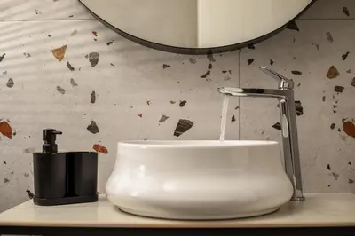 a bathroom sink with a faucet and a mirror at Casa Anastasia in Pastida