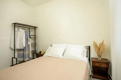 a bed with white sheets and pillows in a bedroom at Casa Anastasia in Pastida