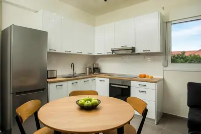 a kitchen with a table with a bowl of fruit on it at Casa Anastasia in Pastida