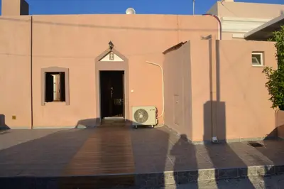 a door to a building with a fan next to it at michaelas traditional house in Phanaes