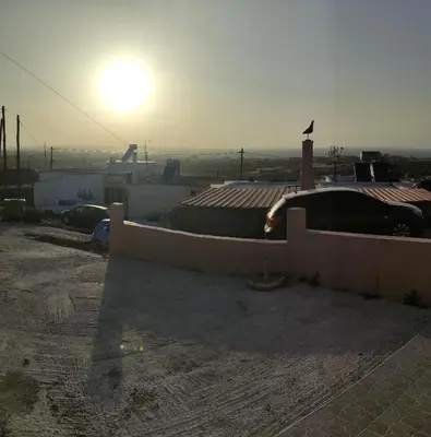 a view of a rooftop with the sun in the background at michaelas traditional house in Phanaes