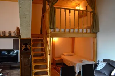 a room with a bunk bed and a ladder at michaelas traditional house in Phanaes